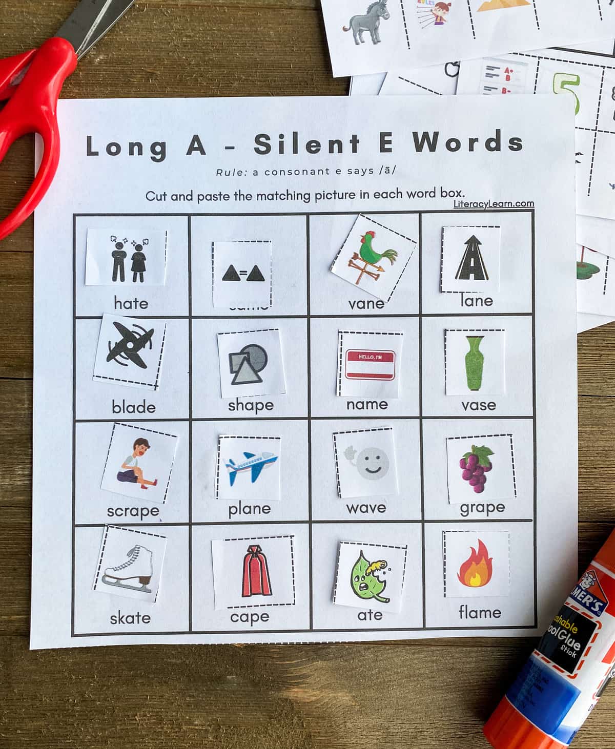 A completed Silent A word picture match worksheet with a glue stick and scissors. 