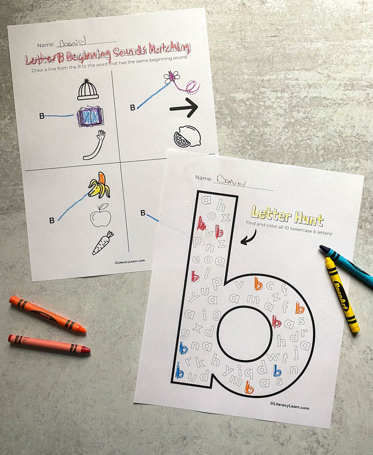 Two printed letter B worksheets with crayons.