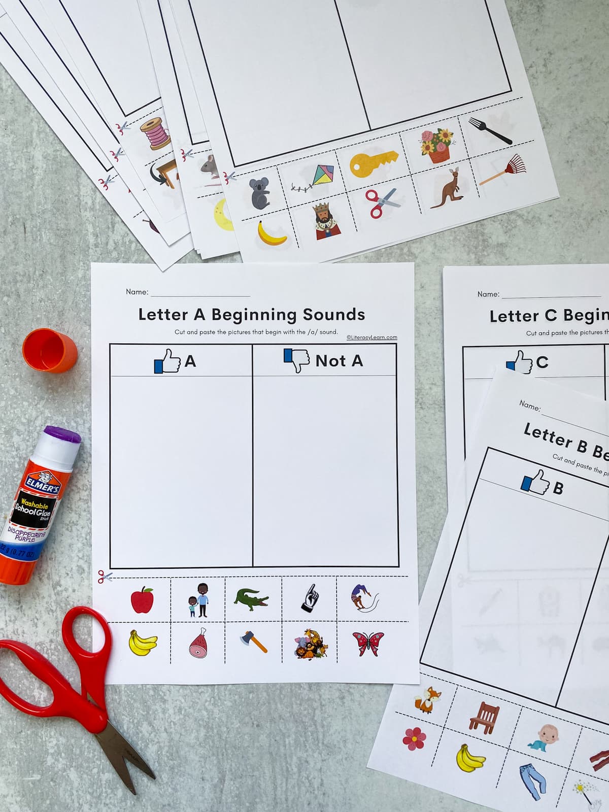 All the a-z beginning sounds cut and paste worksheets laid out with scissors and glue. 