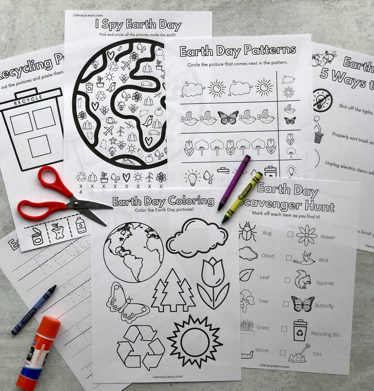 The printed earth day worksheets with crayons, scissor, and glue stick. 
