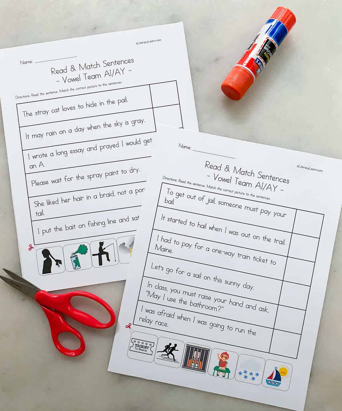 The printed ai/ay worksheets with scissors and a glue stick. 