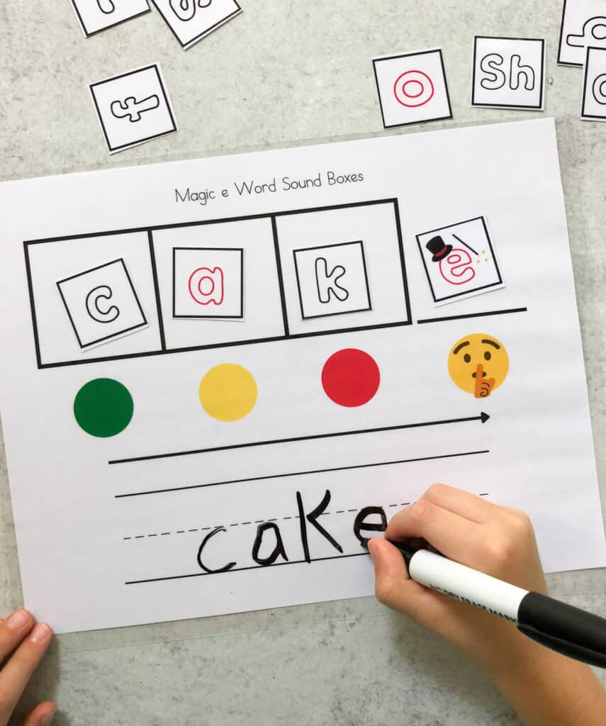 A child mapping the word "cake" using a sound box printable. 