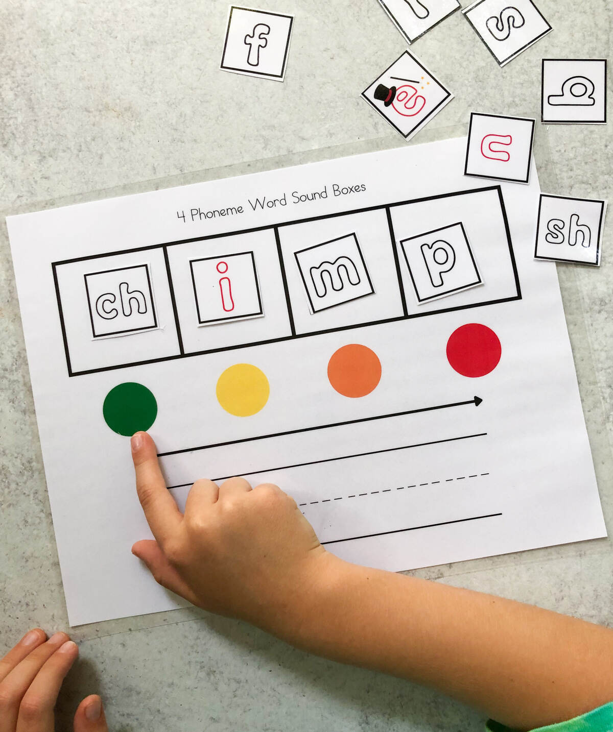 Four phoneme elkonin box worksheet with a child mapping the word "chimp."