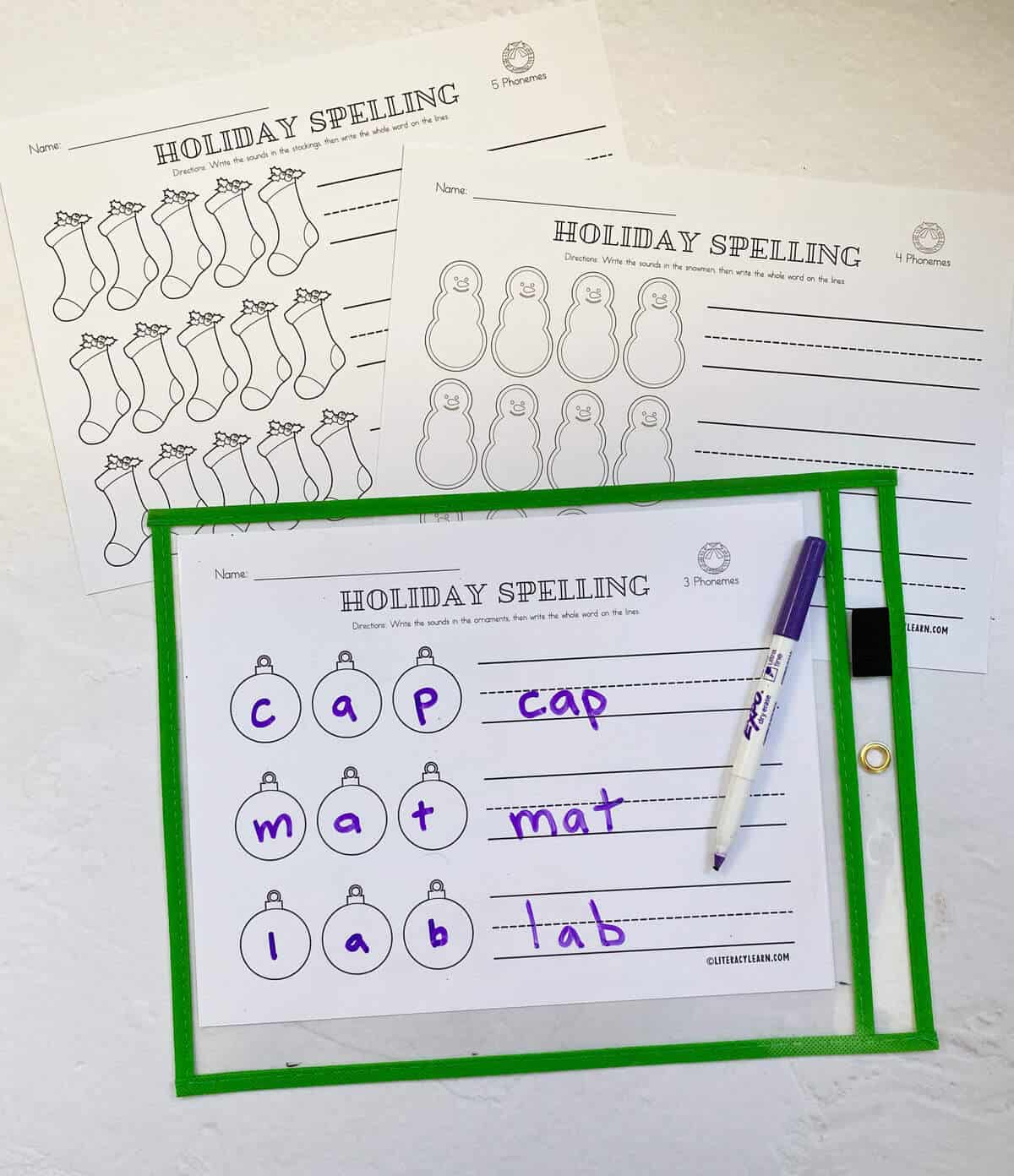 Three printed word mapping worksheets and the 3 phoneme worksheet in a plastic sleeve.