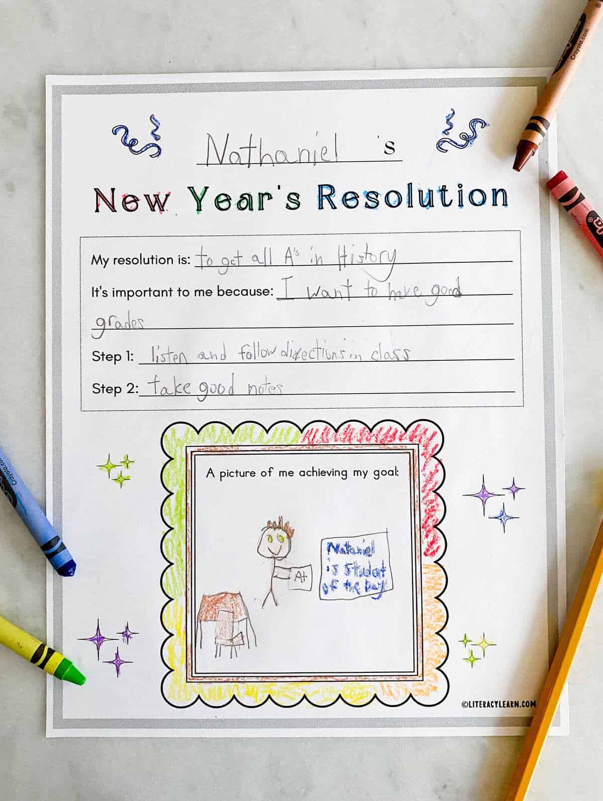 A printed and finished new years resolution worksheet with crayons.