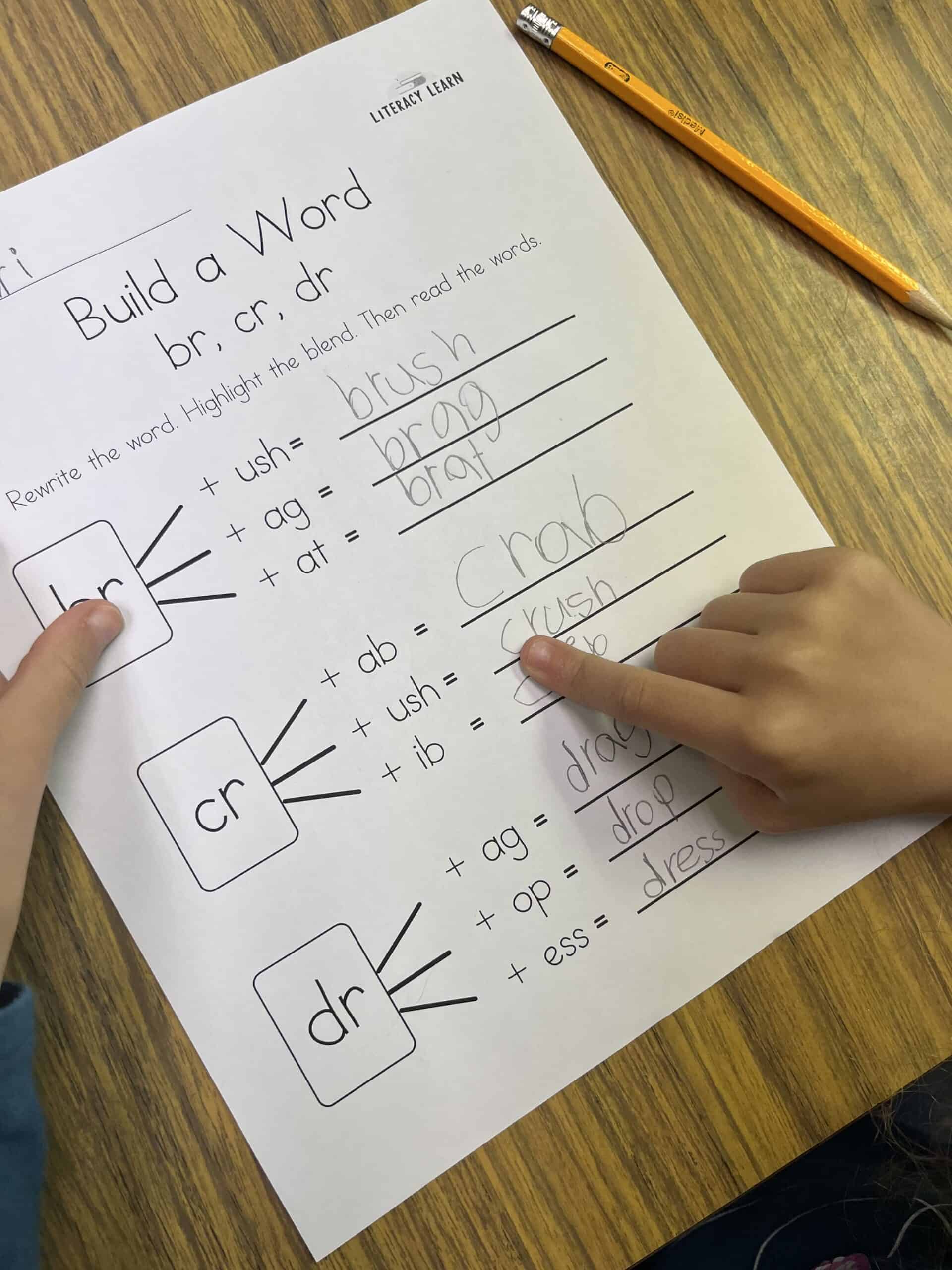A completed r-blend worksheet with a student pointing and reading each r-blend word.