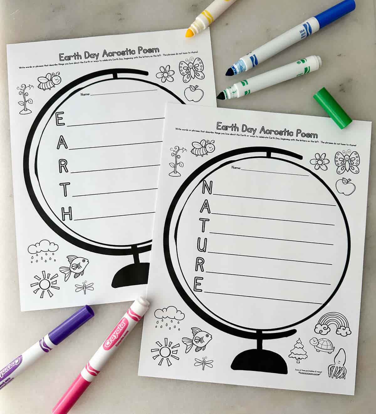 Two printed Earth Day Acrostic Printable Worksheets with Crayola markers. 