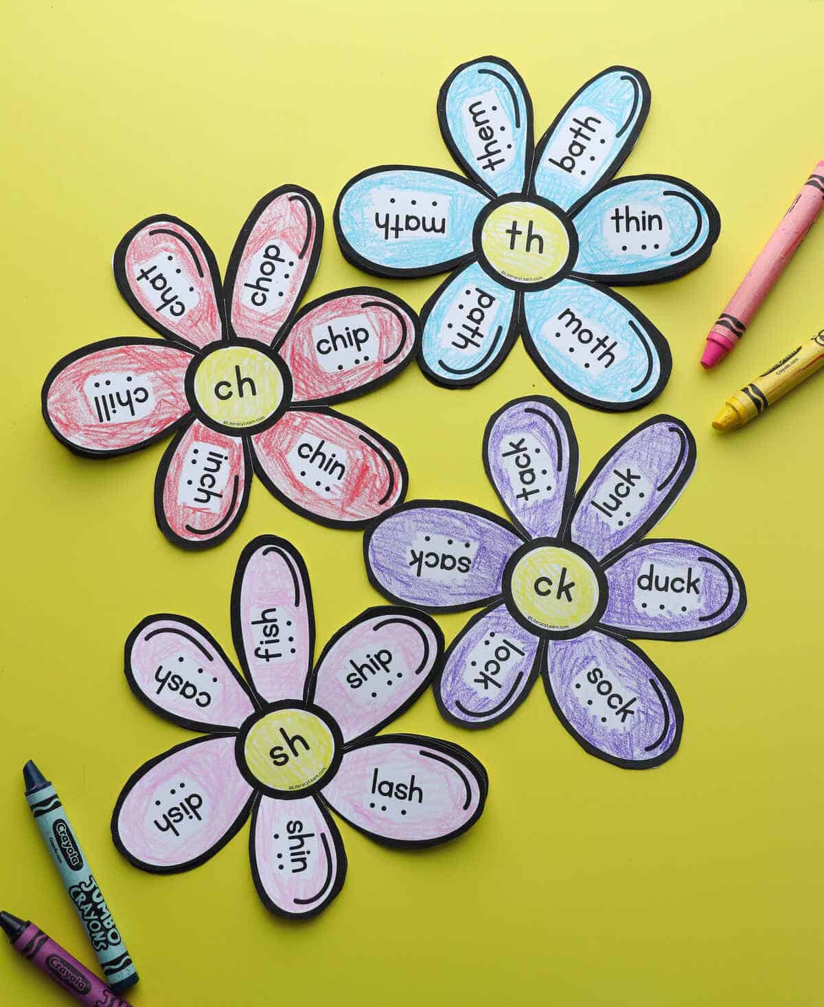 Four read-and-spell flowers with crayons, each with words featuring different digraphs.
