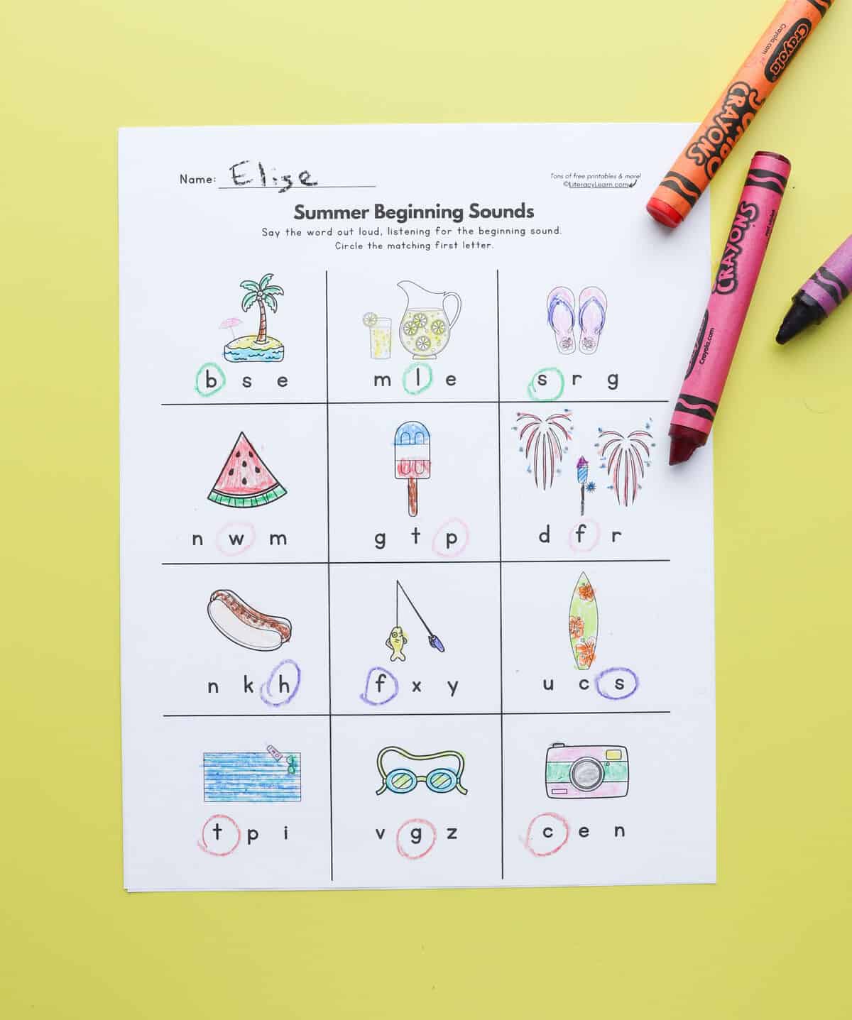 A printed summer-themed initial sounds worksheet on a yellow background.