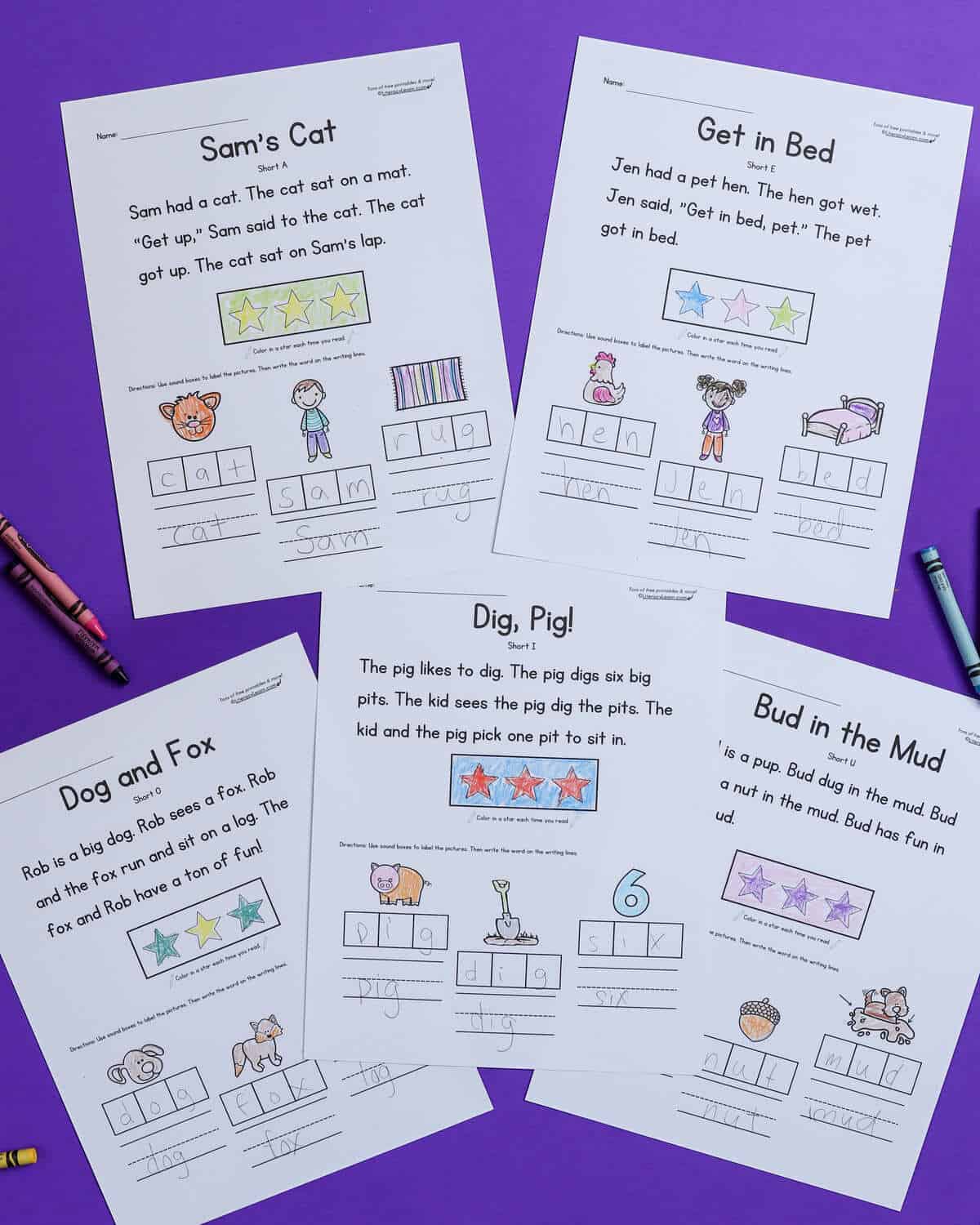 Five printed and completed CVC word decodable story worksheets on a purple background.