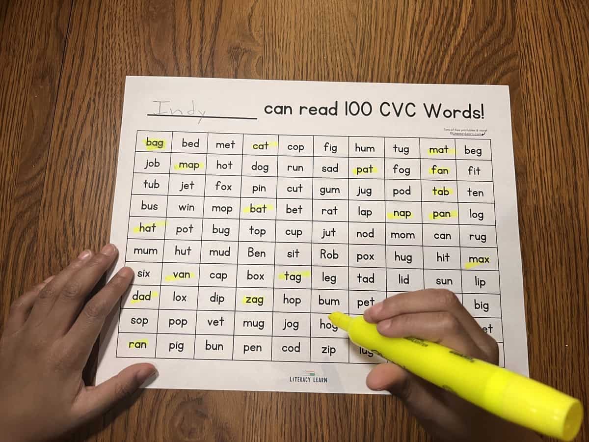 Student highlighting the short a words on the 100 word CVC worksheet.