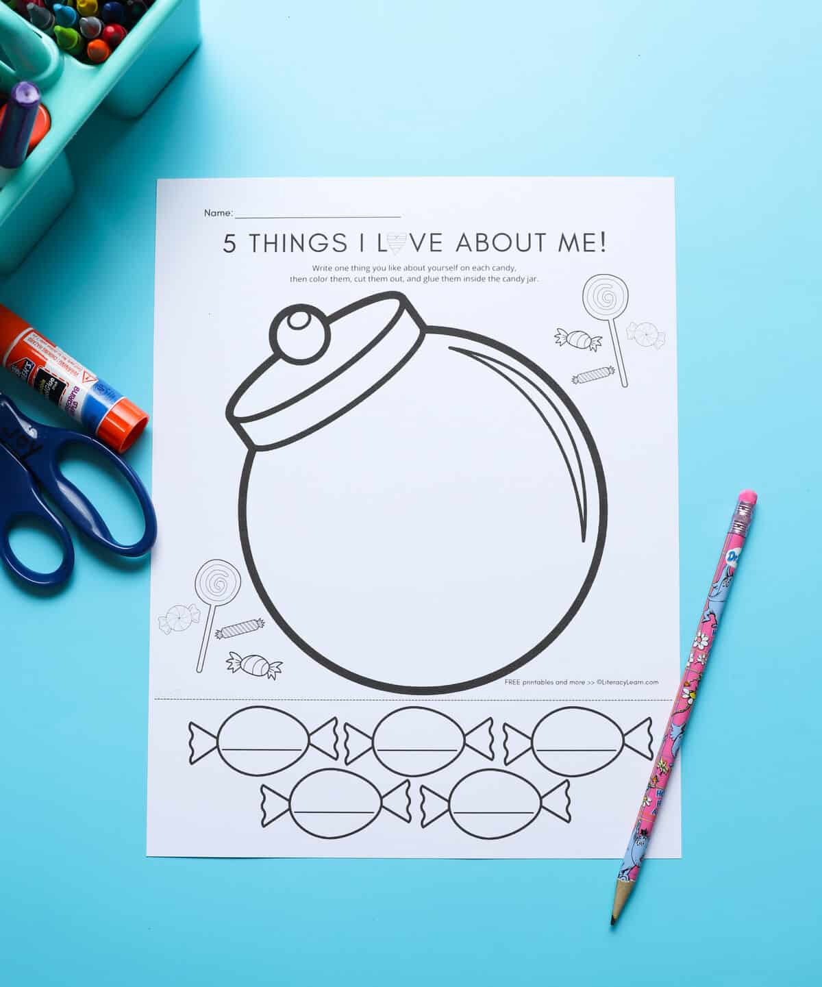 The printed I love me candy jar worksheet with crayons and a scissor.