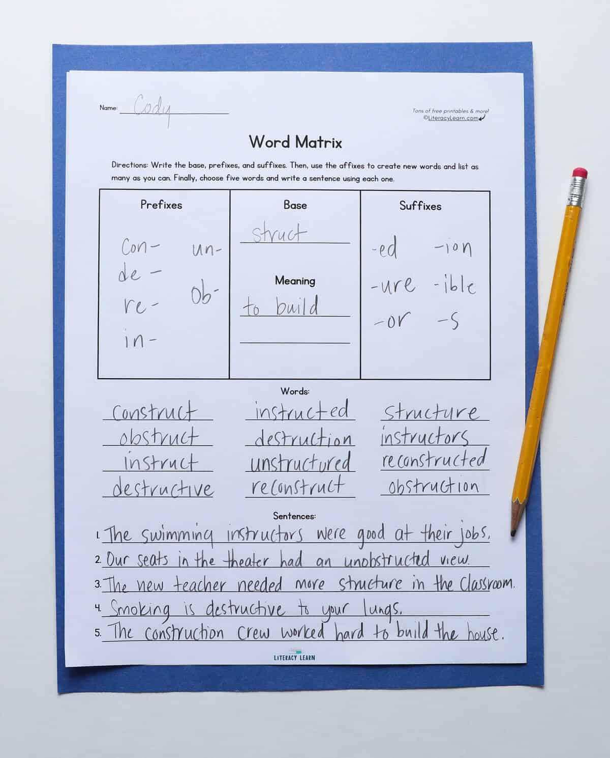 Photograph of a student's completed word matrix and a pencil.