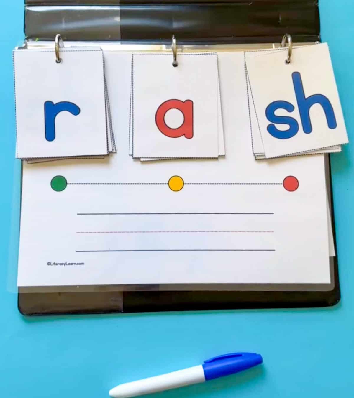 A blending board with grapheme cards that read the word "rash."