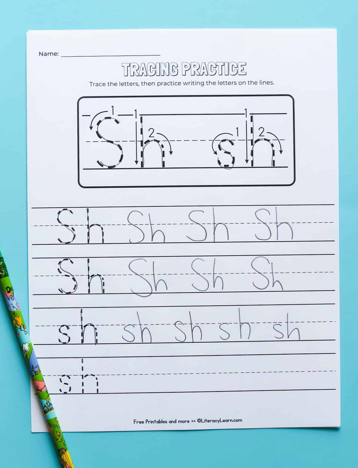 A tracing and writing practice digraph sh worksheet with a pencil.