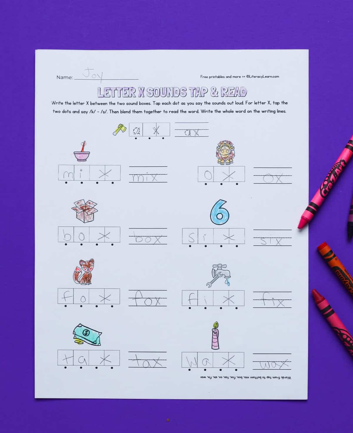 A printed and completed letter x worksheet with a student mapping words containing the letter x.
