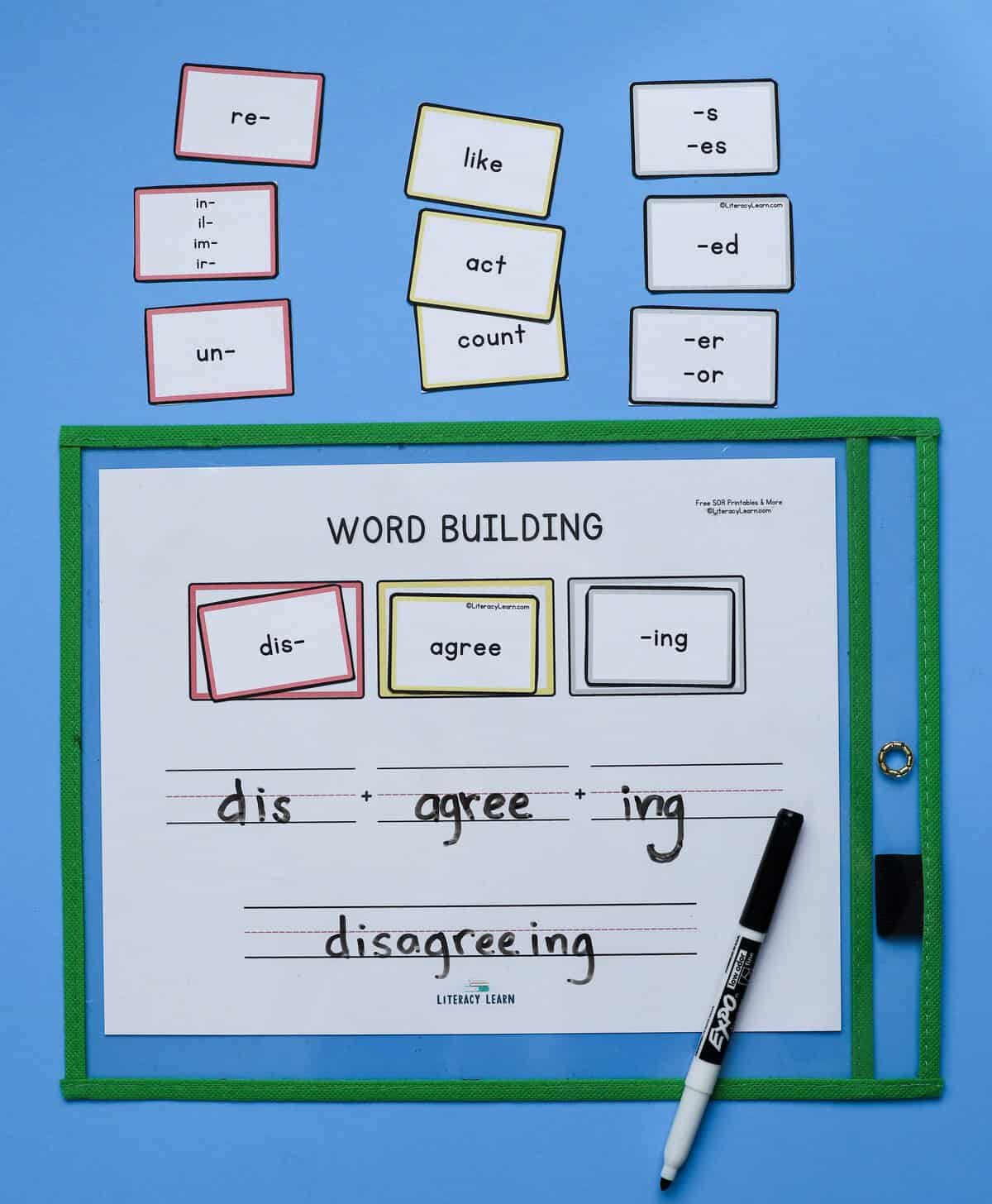 Photograph of a printed word building mat with prefix, suffix, and base cards.