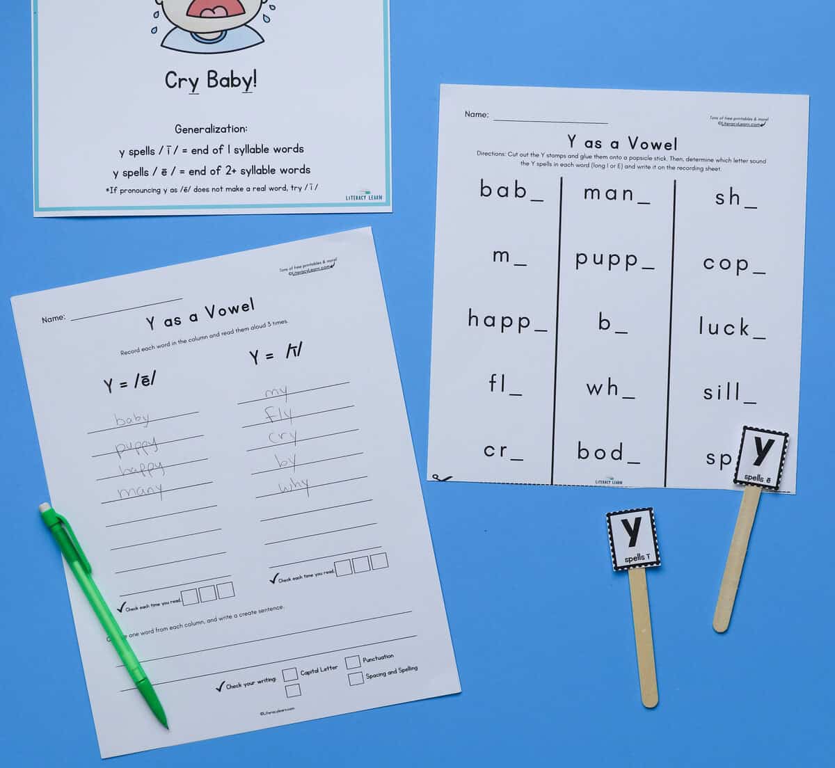 The printed Y as a vowel practice sheet and recording sheet on a blue background.