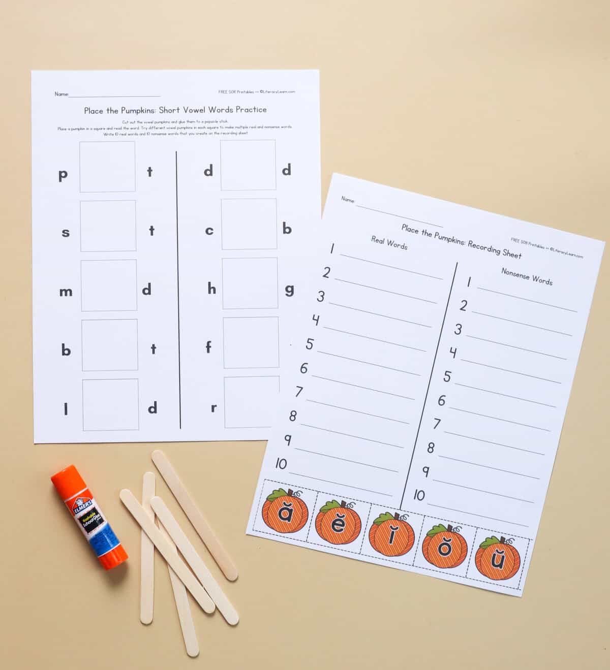 A printed word building and recording sheet with short vowels written on pumpkins. 