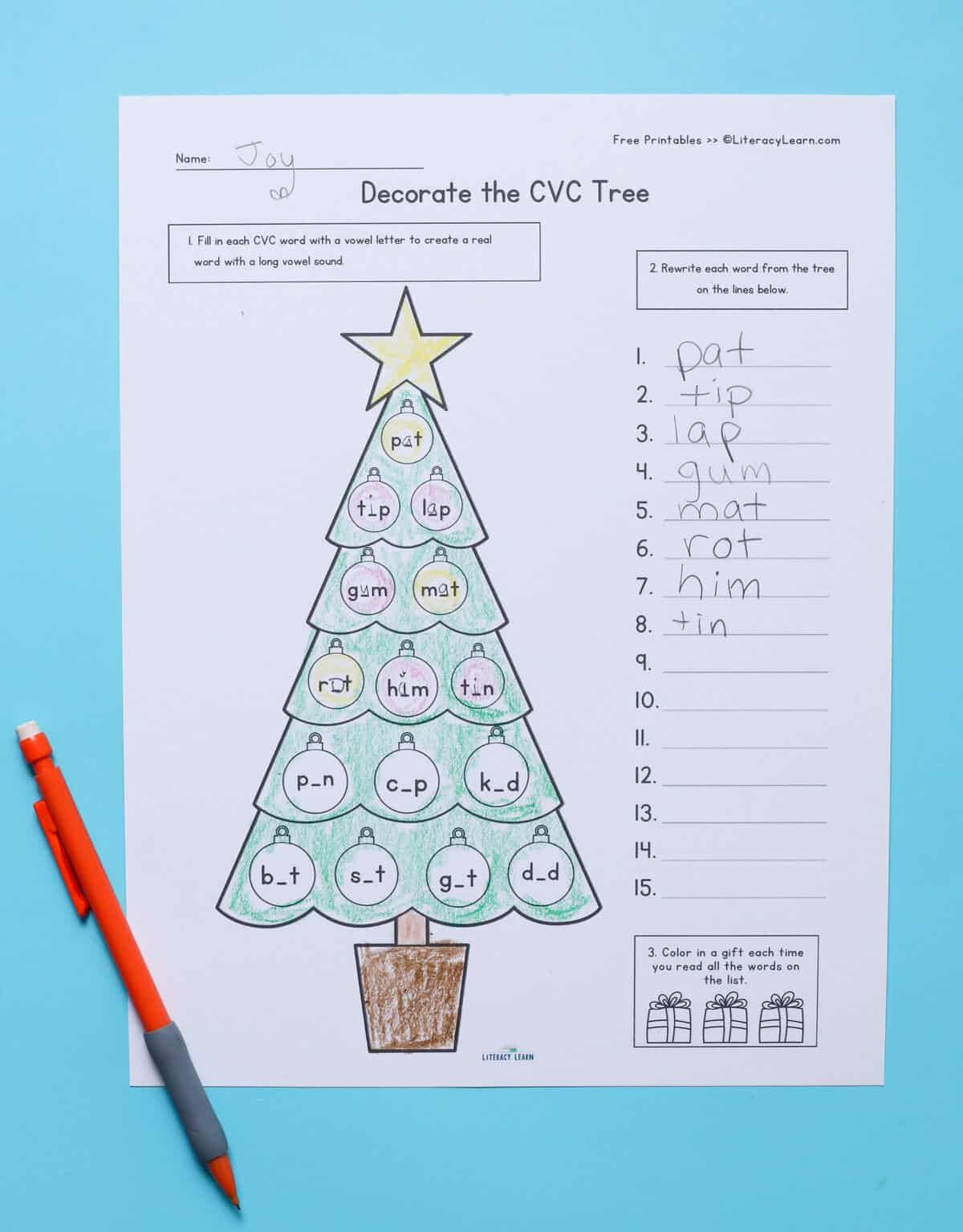 A printed Decorate the Christmas Tree worksheet with missing middle vowels in CVC words. 