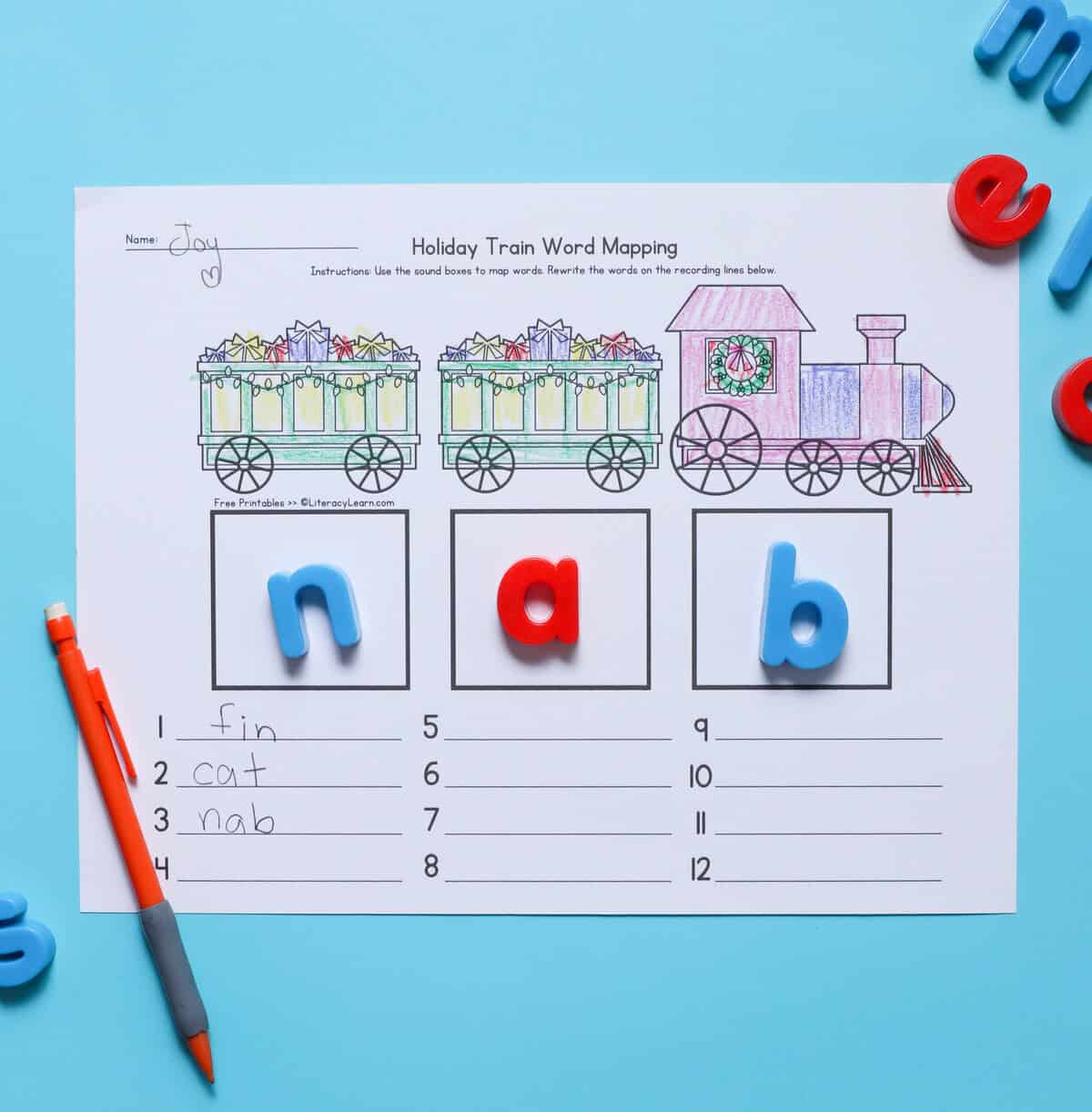 A printed holiday train CVC word mapping worksheet with magnet letters. 