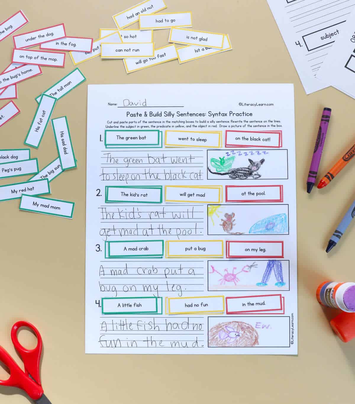 A printed and completed build a sentence worksheet with crayons.