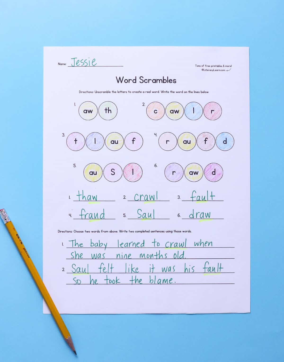 A completed au/aw word scramble worksheet with a pencil.