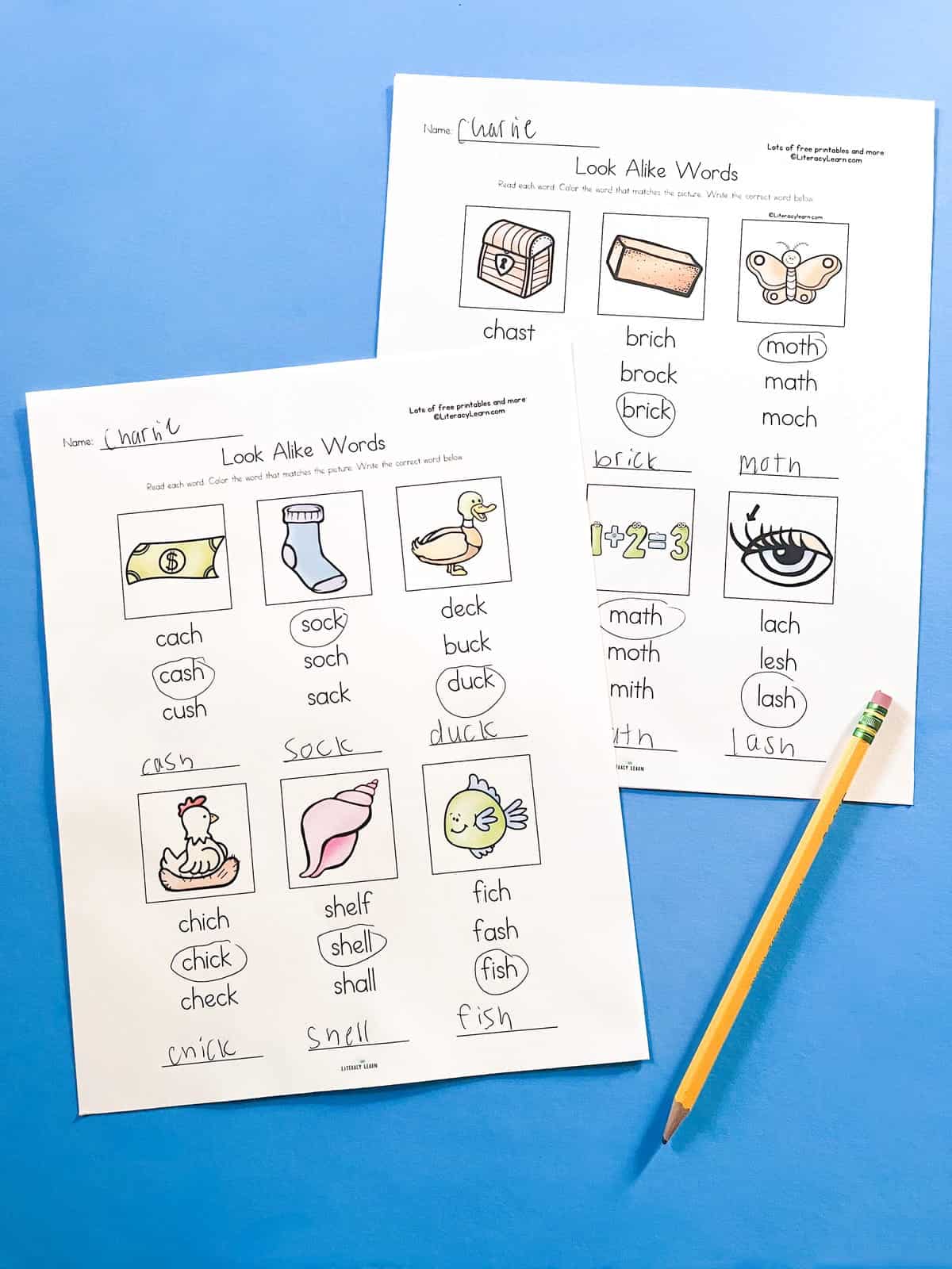 Photo of two digraph look-alike worksheets and pencils on a blue background.