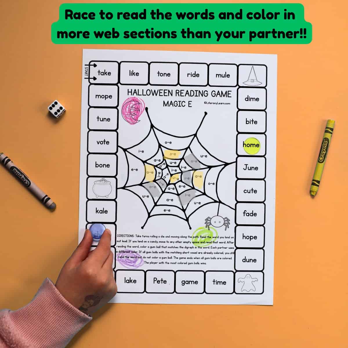 A child's hand using a VCe game board.