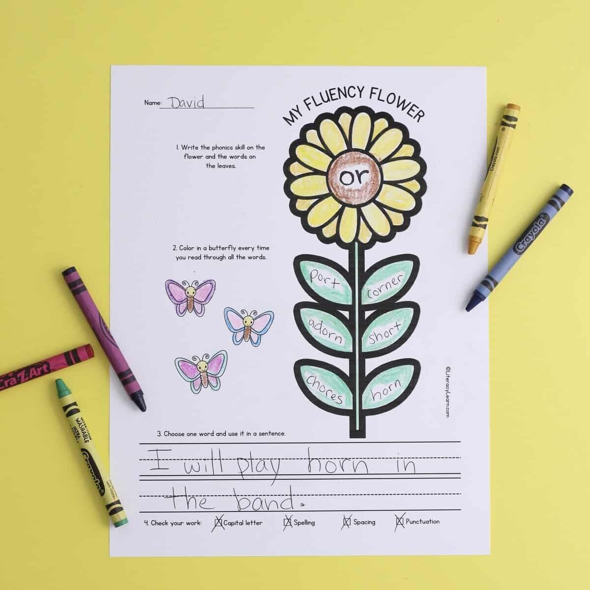 A printed fluency flower worksheet with crayons.